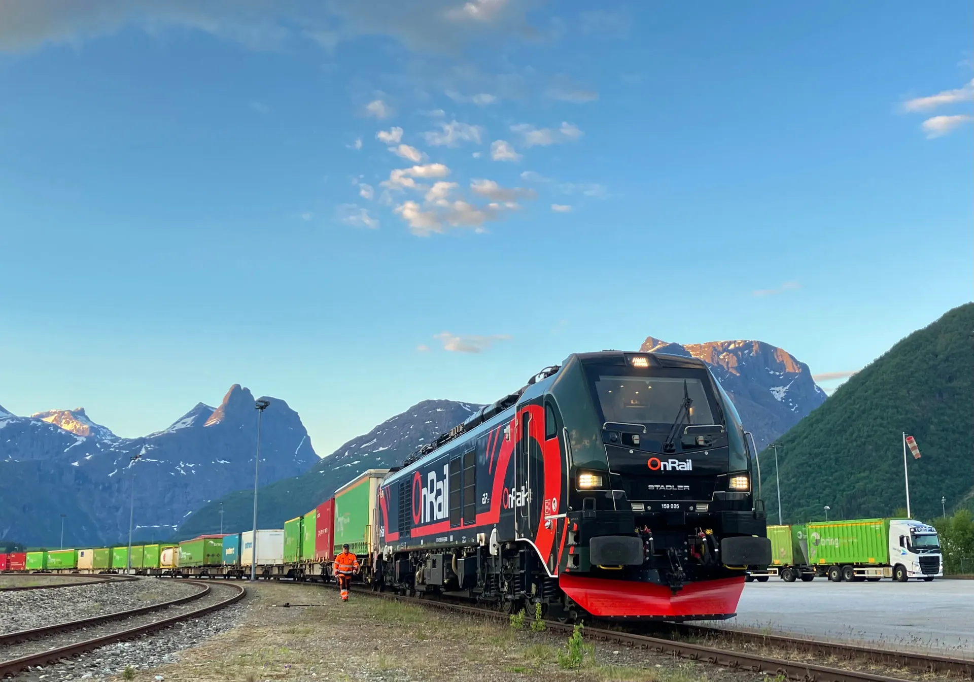 OnRail's EuroDual locomotive with a container train at Åndalsnes, Romsdalshornet in the background