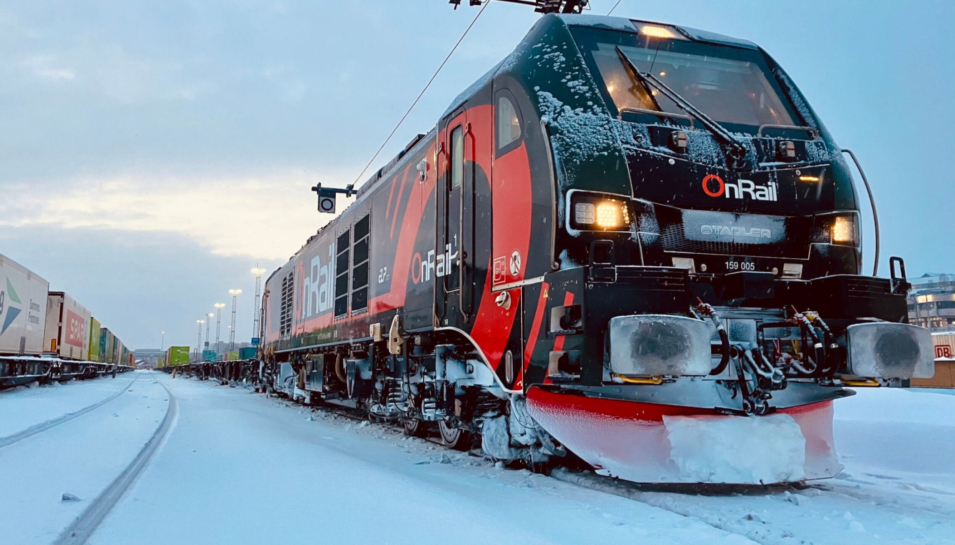 OnRail's EuroDual locomotive in a winter landscape with snow-covered tracks