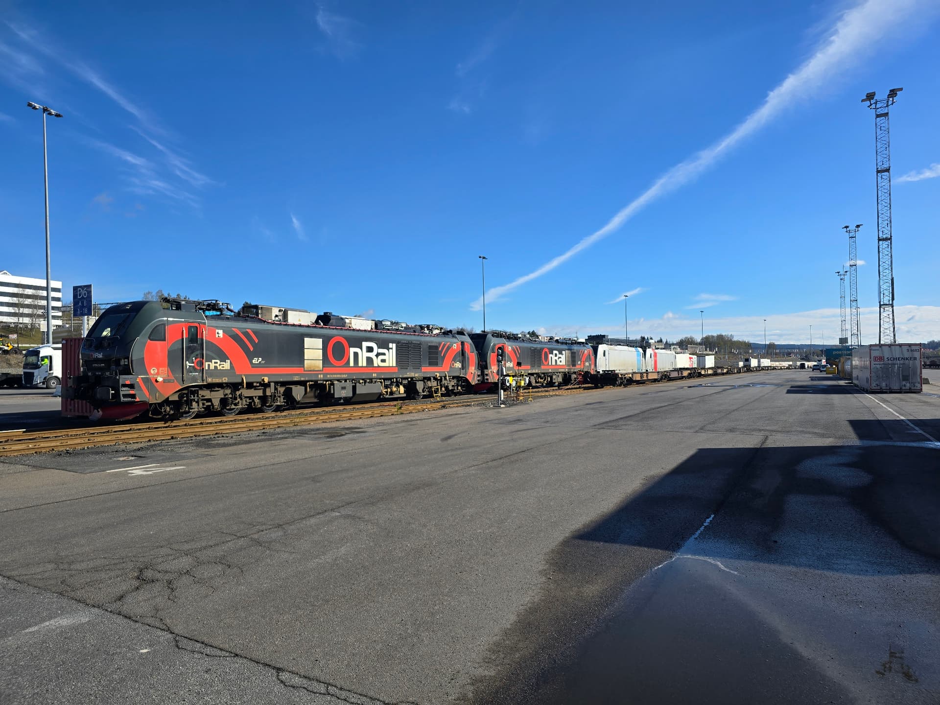 Locomotive change at Alnabru: two OnRail locomotives in front of a container train on a clear spring day