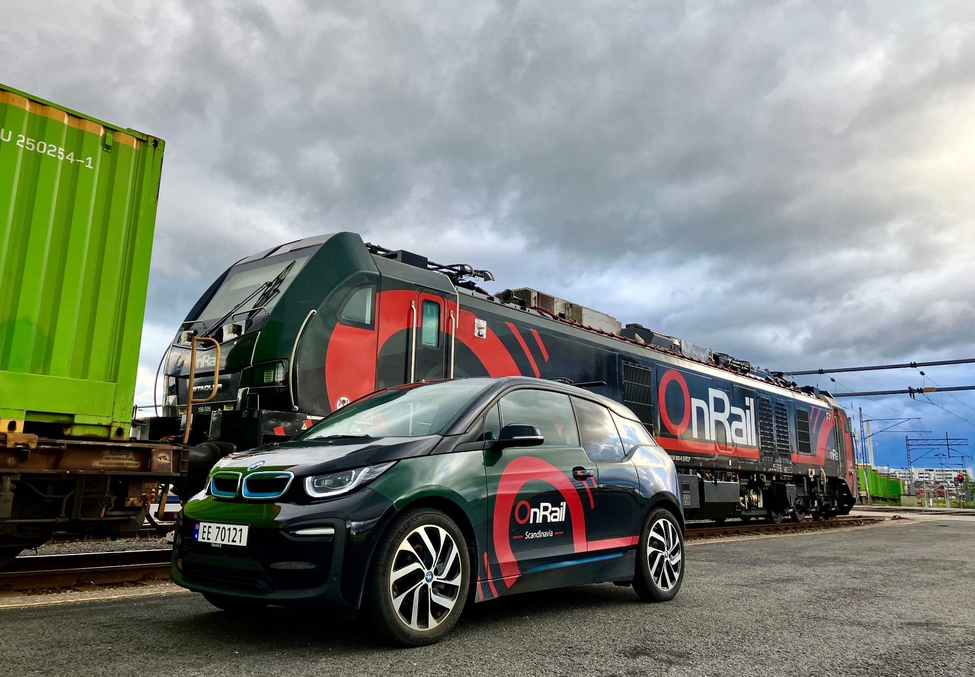 OnRail's electric company car in front of an EuroDual locomotive at the terminal